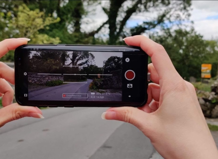 first person view of a smartphone in landscape mapping a street